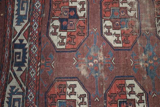 A Bokhara burgundy ground carpet 287 x 172cm